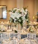 Tall Blush %26 Ivory Centerpiece in Ballroom
Photography: Palos Studio
Read More:
http://www.insideweddings.com/weddings/ocean-view-ceremony-classic-reception-with-soft-blue-color-scheme/1371/ wedding reception hotel ballroom tall white hydrangea pink rose centerpiece blue glassware goblet