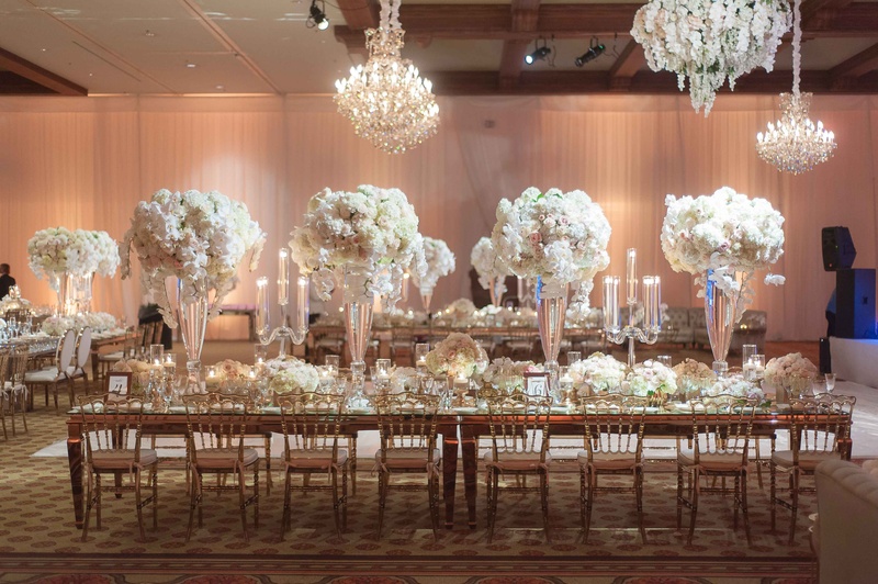 Long Reception Table with Amber Chairs
Photography: The Yodsukars
Read More:
http://www.insideweddings.com/weddings/glam-10th-wedding-anniversary-party-vow-renewal-in-california/917/ Long reception table in ballroom with tall centerpieces chandeliers mirror details candelabra