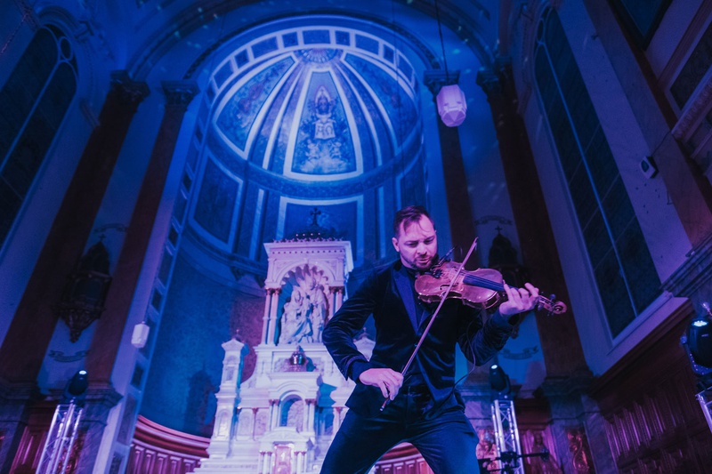 Electric Violinist at Wedding Reception
Photography: Joel %26 Justyna
Read More:
http://www.insideweddings.com/weddings/dreamy-winter-destination-wedding-in-an-ice-castle-in-quebec-city/1270/ Dr. Draw electric violinist performing at wedding reception old catholic church blue purple lighting