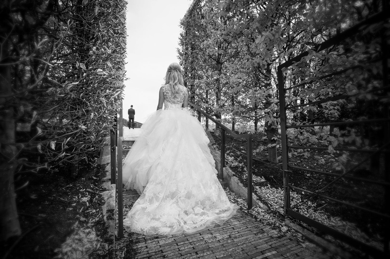 Dramatic "First Look" Approach
Photography: Carasco Photography
Read More:
http://www.insideweddings.com/weddings/traditional-ceremony-glamorous-garden-inspired-tented-reception/943/ Black and white photo of bride in Vera Wang ball gown approaching groom for first look