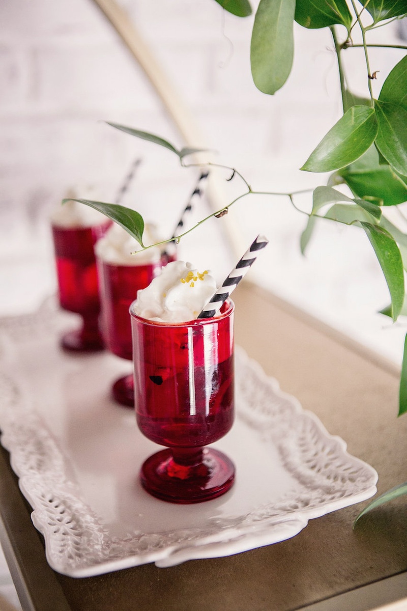 Drinks in Ruby Glasses Photography: Kristina Lee Photography Read More: http://www.insideweddings.com/weddings/inspirational-wedding-shoot-with-black-red-white-geometric-decor/700/ Wedding reception drinks, black and white straw, whipped cream, golden sugar in small red glasses