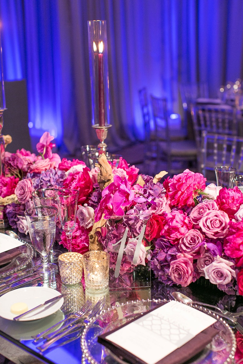 Pink and Purple Floral Table Runner on Glass Table
Photography: Katie Stoops Photography
Read More:
http://www.insideweddings.com/weddings/bright-playful-oceanfront-wedding-with-delectable-four-course-menu/757/ pink purple floral table runner roses glass table glass plateware blue uplighting