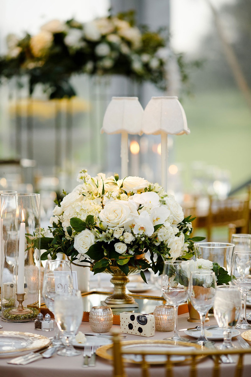 Classic Centerpiece %26 Disposable Camera
Photography: Studio This Is
Read More:
http://www.insideweddings.com/weddings/traditional-catholic-ceremony-classic-country-club-reception/1360/ wedding reception table round table taper candles gold vase with white flowers greenery centerpiece