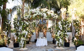 Floral-Encrusted Chuppah
Photography: Jay Lawrence Goldman Photography
Read More:
http://www.insideweddings.com/weddings/rustic-vintage-outdoor-ceremony-tent-reception-in-palm-springs/692/ Wedding flower arch with branches, green leaves, white roses, and orchids