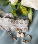 Jewelry and Garter
Photography: Erin Wilson Photography
Read More:
http://www.insideweddings.com/weddings/timeless-wedding-with-white-black-and-gold-palette-in-little-rock/993/ lace garter, aquamarine and pearl earrings, yellow gold solitaire diamond engagement ring