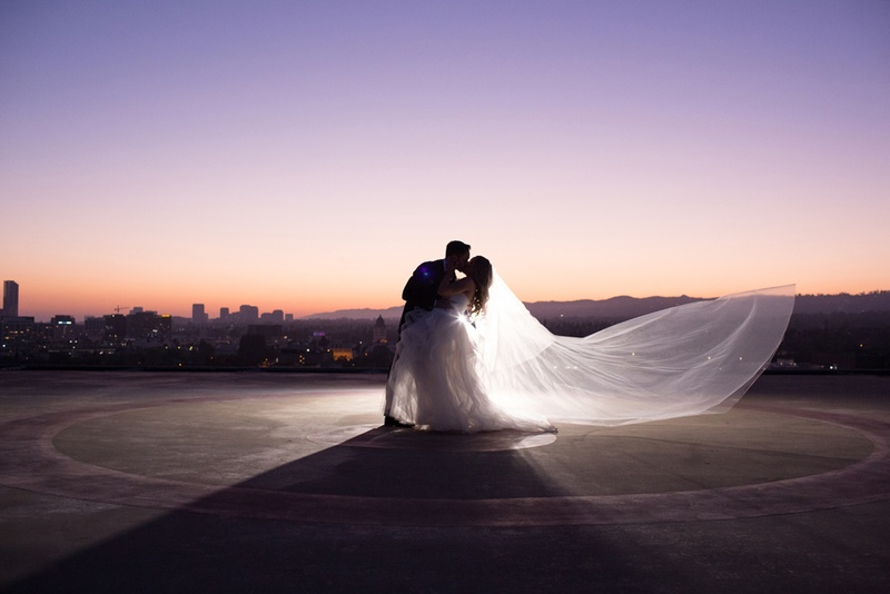 Newlyweds on Rooftop at Sunset
Photography: Duke Photography
Read More:
http://www.insideweddings.com/weddings/jewish-ceremony-classic-ballroom-reception-in-beverly-hills/922/ groom dips bride, veil blowing in wind, rooftop picture of newlyweds at sunset
