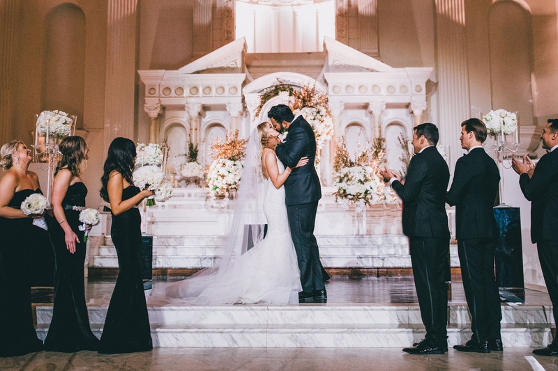 First Kiss at Vibiana Altar
Photography: Jimmy Bui Photography
Read More:
http://www.insideweddings.com/weddings/elegant-edgy-wedding-inspired-by-disney-at-vibiana-in-downtown-la/1229/ bride and groom kiss on marble steps altar wedding ceremony vibiana venue bridesmaids in black