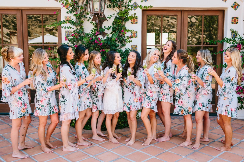 Bride with Bridesmaids in Light Blue Robes
Photography: Jodee Debes Photography
Read More:
http://www.insideweddings.com/weddings/outdoor-ceremony-reception-with-bright-color-palette-at-la-ranch/1280/ bride with white lace robe and bridesmaids in ruffle light blue flower print robe champagne spanish