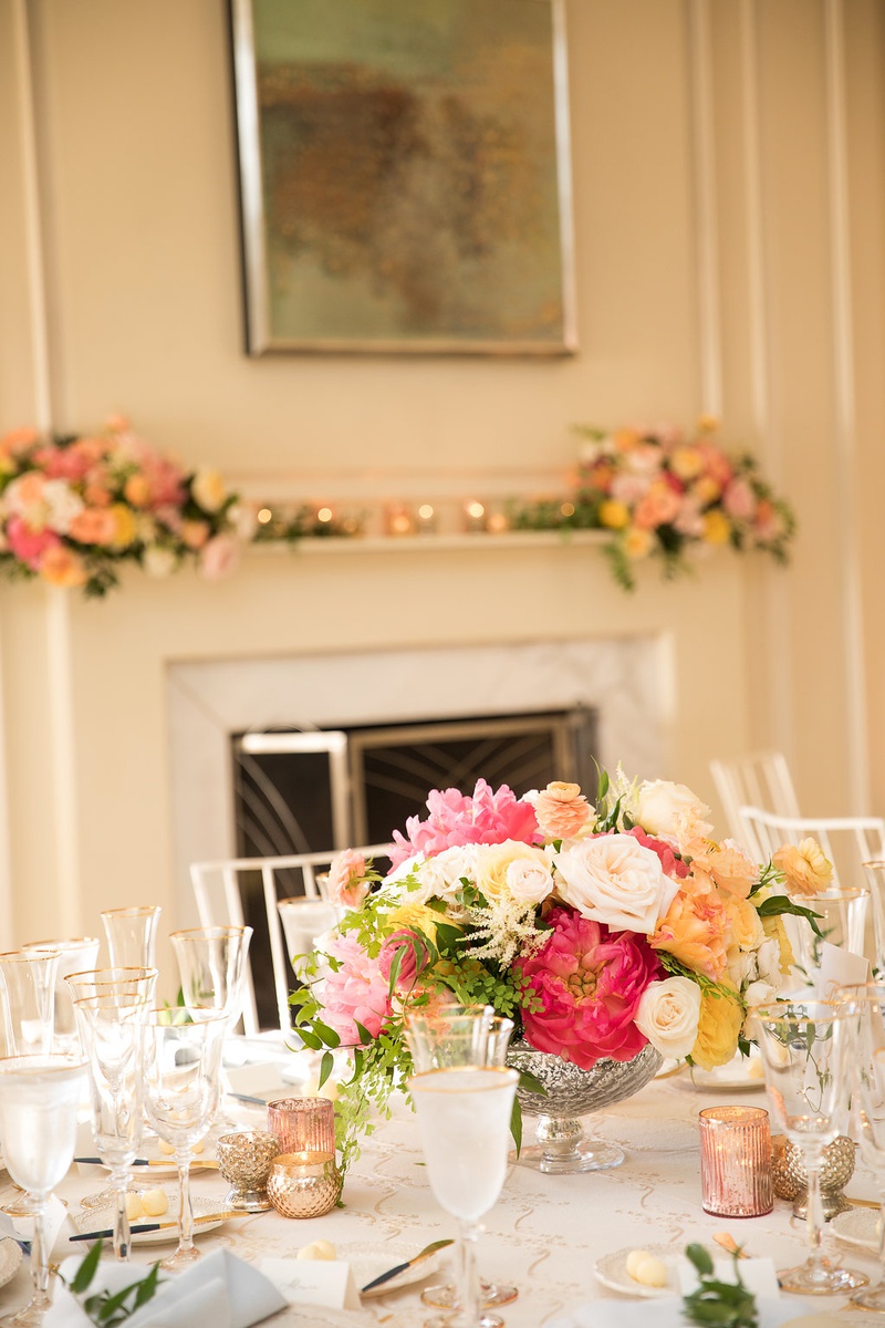 Intimate Reception in Cozy Ballroom
Photography: Ashley Paige Photography
Read More:
http://www.insideweddings.com/weddings/romantic-ocean-view-ceremony-charming-reception-in-california/1337/ wedding reception table low centerpiece footed vase with pink white yellow orange flowers candles