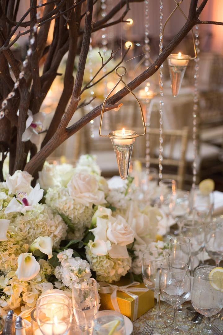 Suspended Candle Votives
Photography: Justin Marantz
Read More:
http://www.insideweddings.com/weddings/unforgettable-miami-wedding-with-acrobats-tiger-cubs-fireworks/437/ Cone shape tea light holders hanging from tree centerpiece