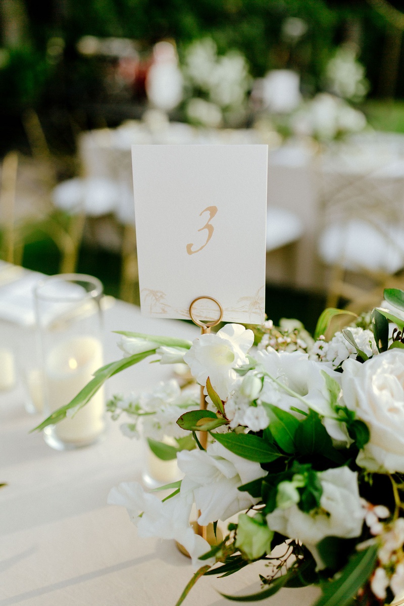 Table Number on Gold Stand
Photography: Chris J. Evans Photography
Read More:
http://www.insideweddings.com/weddings/outdoor-winter-ceremony-and-reception-on-the-big-island-in-hawaii/1306/ outdoor destination wedding reception tropical hawaii decor white flowers greenery gold table number