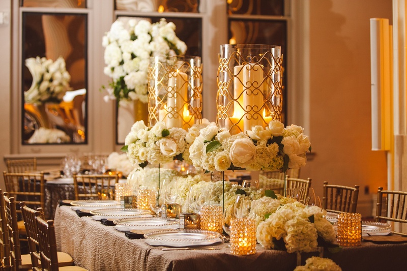 Raised Candle Displays
Photography: J. Cogliandro Photography
Read More:
http://www.insideweddings.com/weddings/angela-mecca-and-owen-daniels/540/ White hydrangea runner and gold-rimmed hurricanes