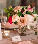 Head Table with Low Floral Centerpiece
Photography: Roey Yohai Photography
Read More:
http://www.insideweddings.com/weddings/elegant-jewish-wedding-at-architectural-landmark-in-new-york-city/1085/ Head table grey reception table candle votive pink roses flowers greenery silver vase simple