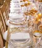 Gold Chargers %26 Glassware on Table
Photography: Duke Photography
Read More:
http://www.insideweddings.com/weddings/grand-wedding-with-regal-decor-and-golden-details-in-washington-dc/1117/ Wedding reception long table mirror gold base gold chairs glassware charger beaded