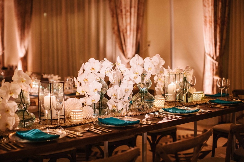 Candlelit Sea-Inspired Table
Photography: Braedon Photography
Read More:
http://www.insideweddings.com/weddings/orthodox-jewish-wedding-with-outdoor-ceremony-inspired-by-the-sea/812/ Wedding reception table wood with table runner, blue vases white orchid flowers in center