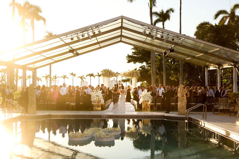 Unique Bridal Processional
Photography: Alain Martinez Photography
Read More:
http://www.insideweddings.com/weddings/opulent-luxury-wedding-with-white-gold-color-scheme-in-palm-beach/1375/ wedding processional with mother and bride pool with floating letter k flower clear top tent sunset
