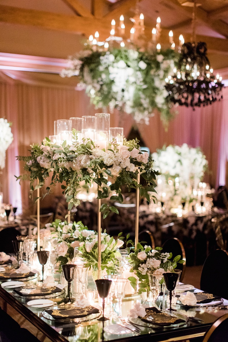 Ivory %26 Greenery Centerpiece on Mirror Table
Photography: Brett Hickman Photographers
Read More:
http://www.insideweddings.com/weddings/charlise-castro-and-george-springer-iii/1165/ Charlise Castro and Houston Astros mlb player George Springer III wedding reception table