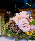 Pastel Floral Arrangement on Table
Photography: Images by Berit, Inc.
Read More:
http://www.insideweddings.com/weddings/bride-wears-little-black-dress-to-intimate-wedding-in-new-york-city/734/ Wedding reception table with pink garden roses, dahlias, green hydrangeas with touches of red