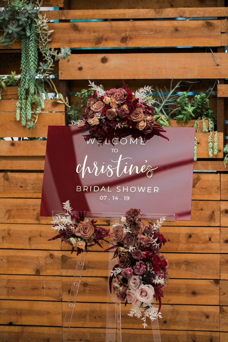 Burgundy Welcome Sign
Photography: Jessica Claire Photography
Read More:
http://www.insideweddings.com/weddings/unique-chic-bridal-shower-with-dark-and-moody-color-scheme/1335/ burgundy acrylic sign with gold lettering and flowers for bridal shower
