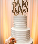 Golden Monogrammed Cake Topper
Photography: Arte De Vie
Read More:
http://www.insideweddings.com/weddings/traditional-church-ceremony-country-club-reception-in-new-orleans/719/ White textured wedding cake with orange flowers, gilded monogrammed topper