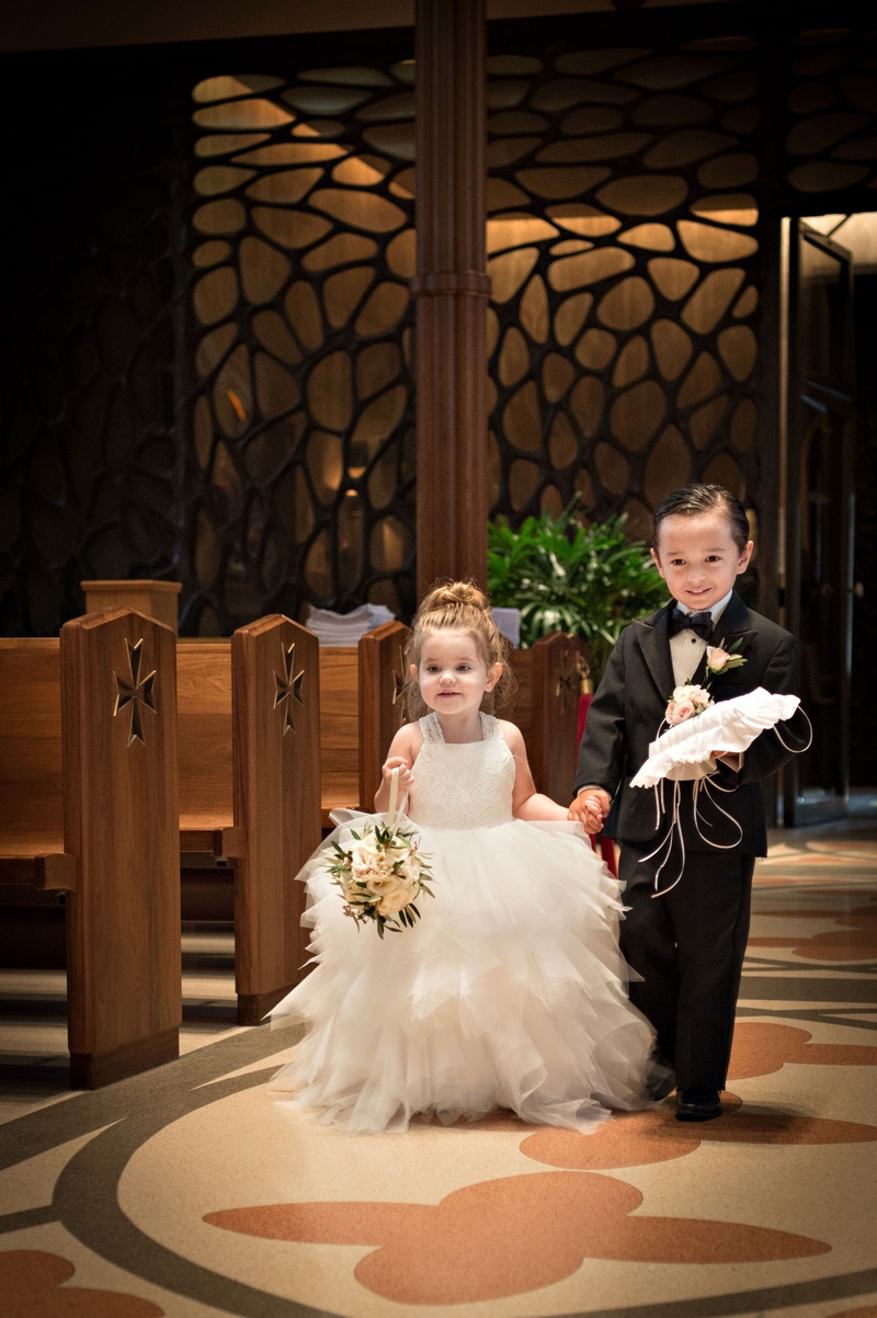 Flower Girl %26 Ring Bearer in Cathedral
Photography: Carasco Photography
Read More:
http://www.insideweddings.com/weddings/traditional-ceremony-glamorous-garden-inspired-tented-reception/943/ Flower girl in tulle white dress with basket and ring bearer in black tux with ring pillow