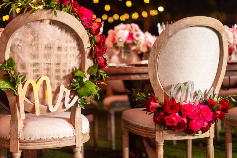 Mr. %26 Mrs. Gold Chair Signs
Photography: Suzanne Delawar Studios
Read More:
http://www.insideweddings.com/weddings/intimate-oceanfront-wedding-with-romantic-red-pink-white-palette/1235/ wedding reception wood round back chair with garland pink red rose flowers gold mr mrs signs