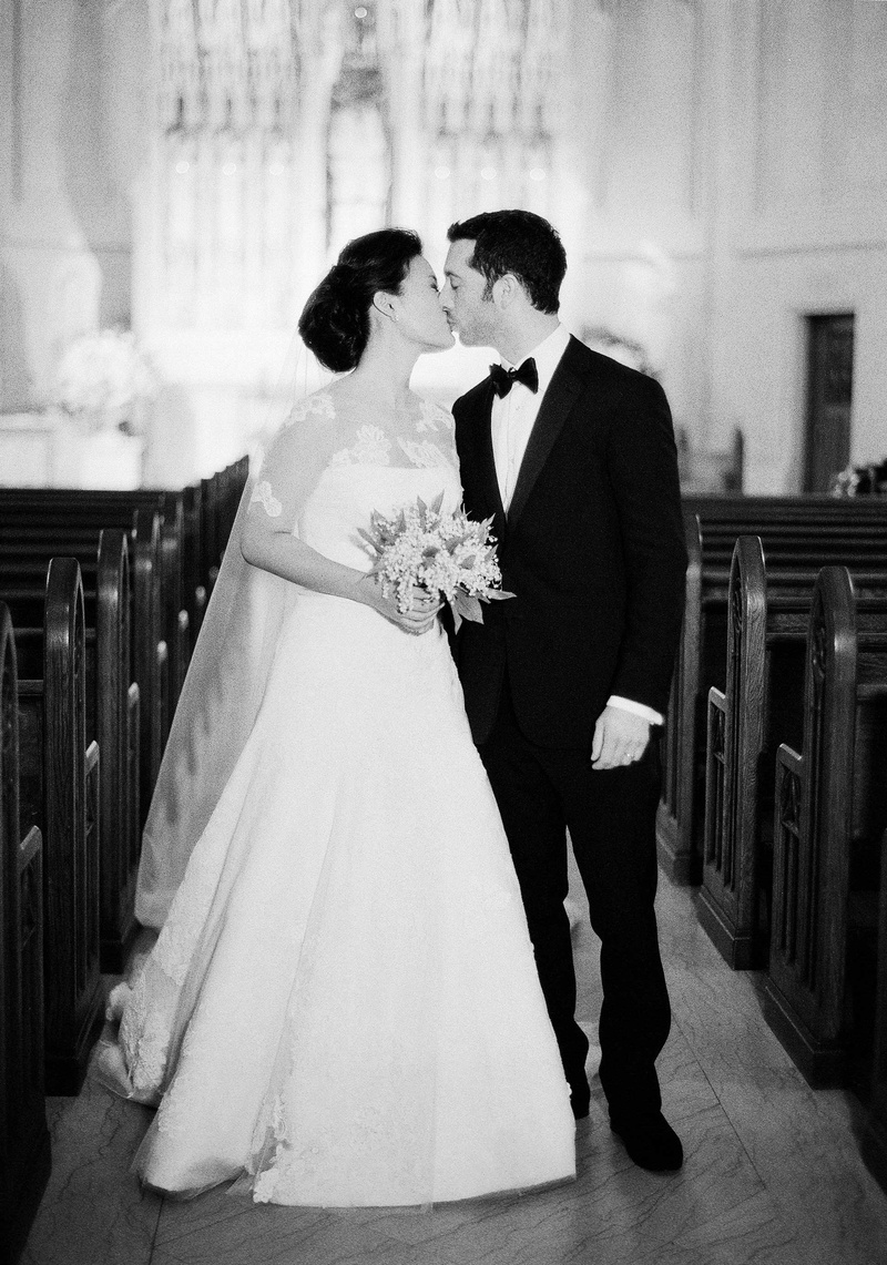 Couple Kissing in Aisle at Chapel
Photography: Jose Villa Photography
Read More:
http://www.insideweddings.com/weddings/glamorous-sophisticated-garden-themed-ballroom-wedding-in-chicago/905/ Black and white photo of couple kissing in church aisle empty pews Saint James Chapel wedding
