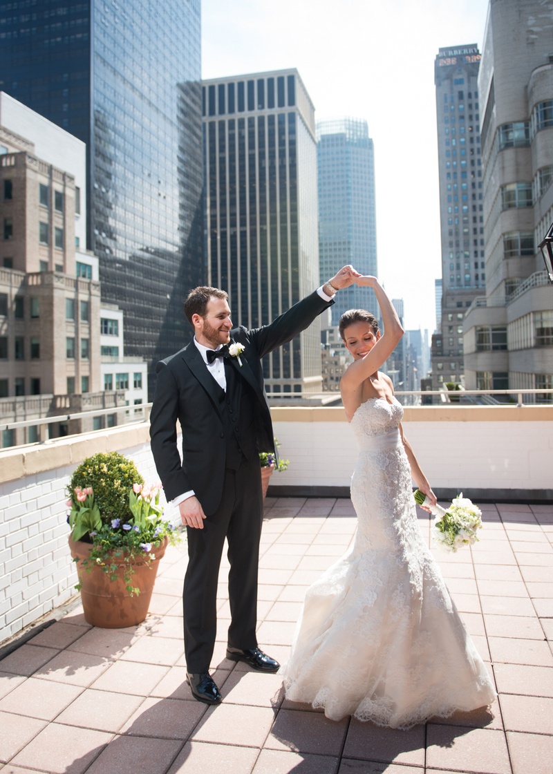 Groom Twirls Bride on Rooftop
Photography: Ira Lippke Studios
Read More:
http://www.insideweddings.com/weddings/chic-classic-new-york-city-wedding-with-personal-touches/783/ groom in a black tuxedo twirling his bride clad in a white wedding gown on a rooftop in nyc