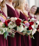 Bridesmaids with Colorful Wintry Bouquets
Photography: Karlisch Photography
Read More:
http://www.insideweddings.com/weddings/a-festive-new-years-eve-wedding-at-an-art-deco-venue-in-dallas/1053/ Bridesmaids in burgundy dresses with colorful bouquets red pink white and greenery