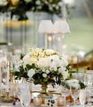 Classic Centerpiece %26 Disposable Camera
Photography: Studio This Is
Read More:
http://www.insideweddings.com/weddings/traditional-catholic-ceremony-classic-country-club-reception/1360/ wedding reception table round table taper candles gold vase with white flowers greenery centerpiece