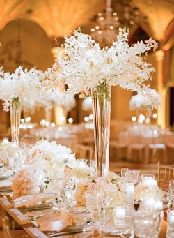 Photography: KT Merry Photography
Read More:
http://www.insideweddings.com/inspiration/board/169/iwadmin2/timeless-white-wedding-details/ Tall fluted vases filled with cascading white orchids