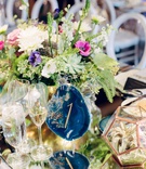 Agate Slice with Table Number
Photography: Rachel Havel Photography
Read More:
http://www.insideweddings.com/weddings/unique-boho-chic-wedding-inspired-by-blue-agate-in-colorado/1362/ slice of blue agate painted with number number, small arrangement with greenery and small blooms