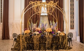 Golden Chain Chandelier
Photography: Duke Photography
Read More:
http://www.insideweddings.com/weddings/dramatic-tablescape-at-launch-party-for-luxe-linens-newest-line/987/ wedding styled shoot, gold chain chandelier, blue delphiniums, black and gold