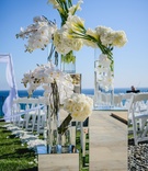 White Floral Bouquets for Aisle
Photography: Viera Photographics
Read More:
http://www.insideweddings.com/weddings/modern-style-seaside-wedding-with-geometric-detailing-in-malibu-ca/813/ White calla lilies, orchids, hydrangea, and roses decorated the aisle.