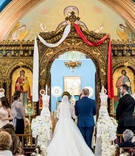 Traditional Greek Orthodox Ceremony
Photography: Lilly Photography
Read More:
http://www.insideweddings.com/weddings/traditional-greek-orthodox-ceremony-ballroom-reception-in-chicago/1105/ Bride and groom at gold altar white and red sash white flowers