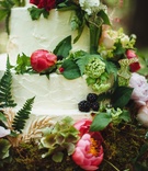Nature-Inspired Wedding Cake
Photography: Veronica Varos Photography
Read More:
http://www.insideweddings.com/weddings/a-bohemian-inspired-wedding-shoot-in-an-enchanted-forest/643/ White wedding cake with hot pink peonies and greenery