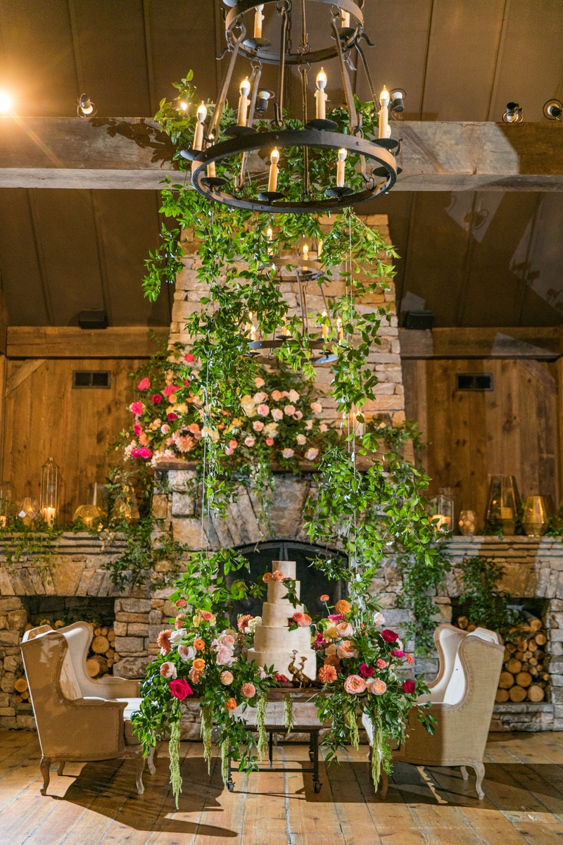 Garden Fireplace %26 Swing Cake Display
Photography: Vue Photography
Read More:
http://www.insideweddings.com/weddings/southern-labor-day-weekend-wedding-with-vibrant-color-palette/1342/ wedding reception stone fireplace greenery cake swing with flowers greens hovering off ground