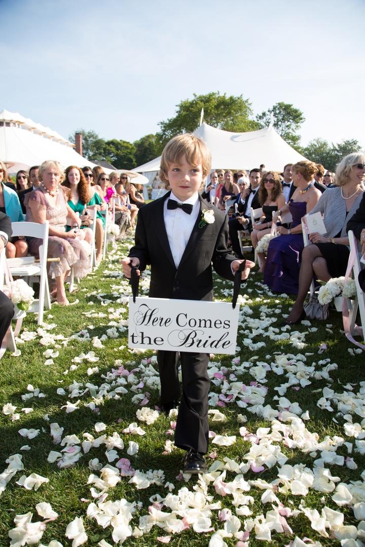 Ring Bearer Sign
Photography: Carrie Rodman Photography
Read More:
http://www.insideweddings.com/weddings/new-england-summer-wedding-by-the-seashore/429/ Ring bearer holds "Here Comes the Bride" signage