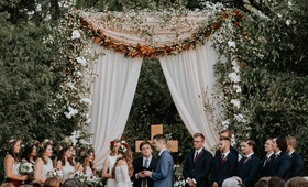 Outdoor Christian Wedding Ceremony
Photography: Grant Daniels Photography
Read More:
http://www.insideweddings.com/weddings/outdoor-ceremony-tented-reception-with-cozy-fall-color-palette/1183/ wedding ceremony outdoor tall arch greenery magnolia leaves cross drapery