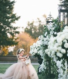 Flower Girl in Champagne Tulle Gown
Photography: Parker J Pfister Photographer
Read More:
http://www.insideweddings.com/weddings/gorgeous-alfresco-ceremony-tented-reception-at-a-luxurious-estate/1044/ Flower girl in champagne tulle ball gown with basket and flower crown gates with white flowers