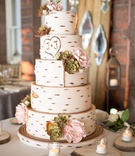 Wedding Cake
Photography: Carrie Rodman Photography
Read More:
http://www.insideweddings.com/weddings/jennifer-walker-and-john-colaneri/543/ White wedding cake made to resemble a birch tree with the couples initials carved on it
