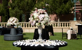 Escort Card Display
Photography: Paul Barnett Photographer
Read More:
http://www.insideweddings.com/weddings/pink-black-wedding-at-the-grand-del-mar-in-san-diego-california/379/ Black round table with pearl-filled vase