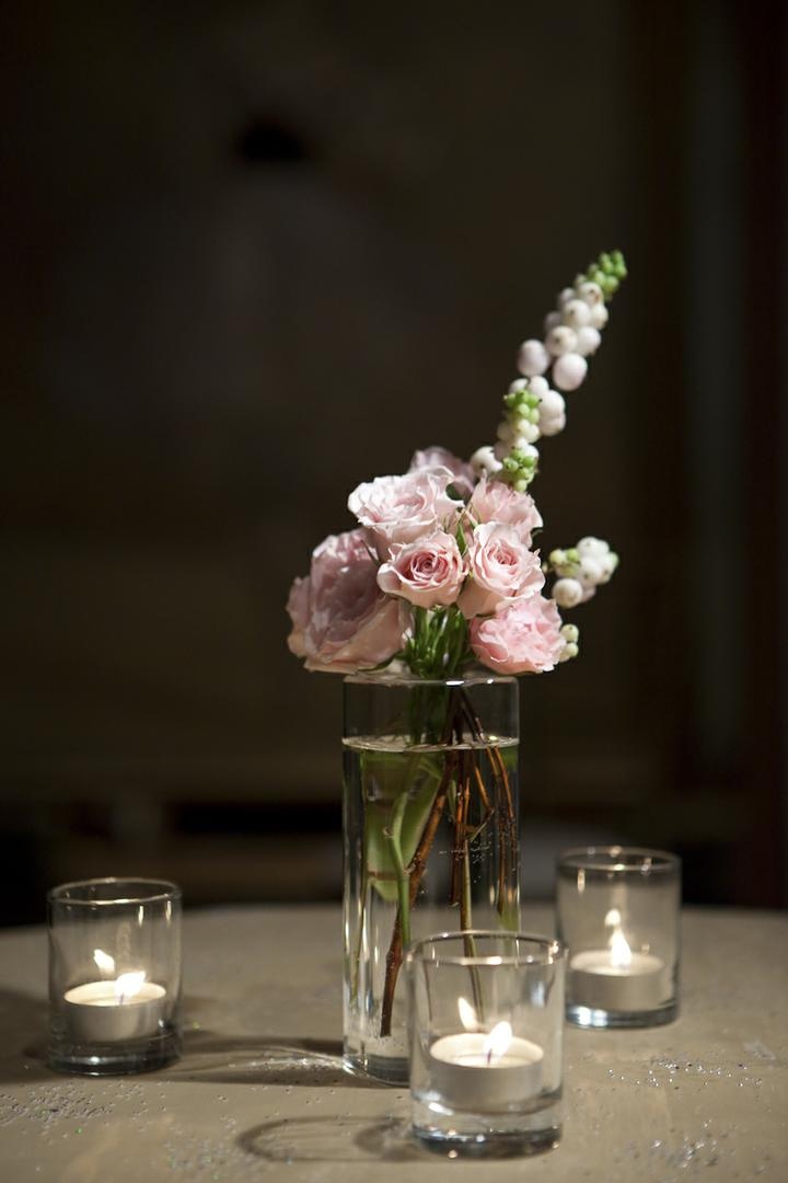 Simple Floral Arrangement
Photography: Catherine Hall Studios
Read More:
http://www.insideweddings.com/weddings/metropolitan-san-francisco-wedding-at-luxury-hotel/411/ Tea lights surrounding small vase with ranunculus