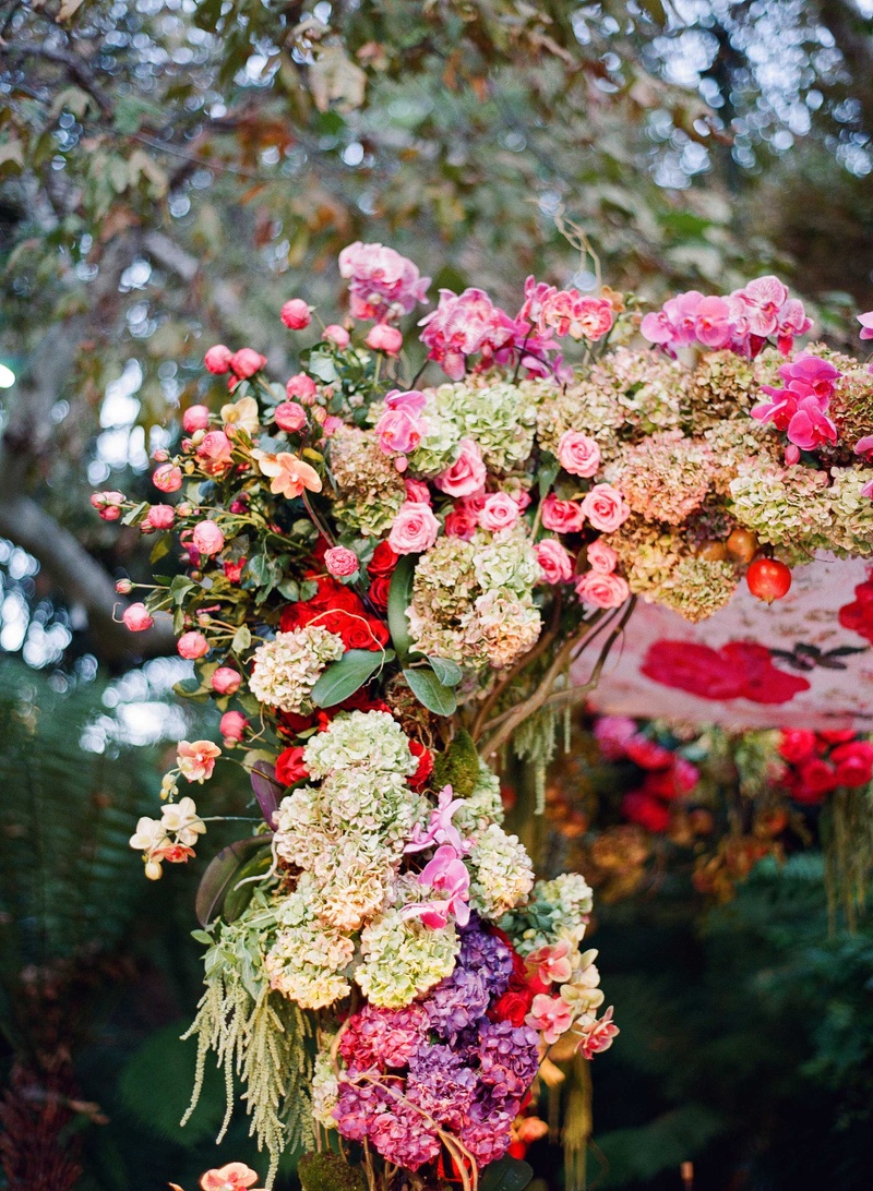 Vibrant Chuppah Wedding Flowers
Photography: Mi Belle Photographers
Read More:
http://www.insideweddings.com/weddings/colorful-outdoor-wedding-with-supper-club-theme-in-los-angeles-ca/741/ Handmade quilt suspended from flower embellished chuppah with pink, red, magenta, and purple flowers