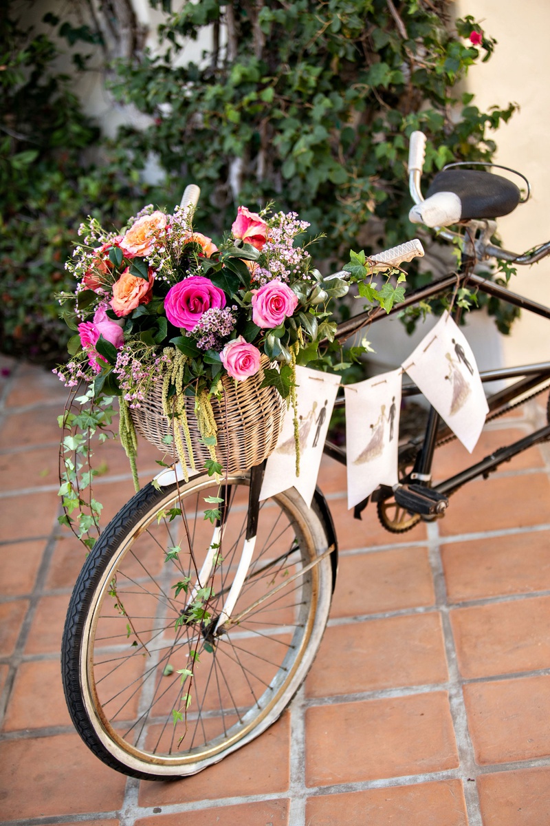 Bike with Bright Flowers in Basket
Photography: Laurie Bailey Photography
Read More:
http://www.insideweddings.com/weddings/outdoor-jewish-ceremony-reception-with-colorful-bohemian-decor/1330/ wedding decor terracotta tile old bike with banner illustration bride groom pink orange flowers