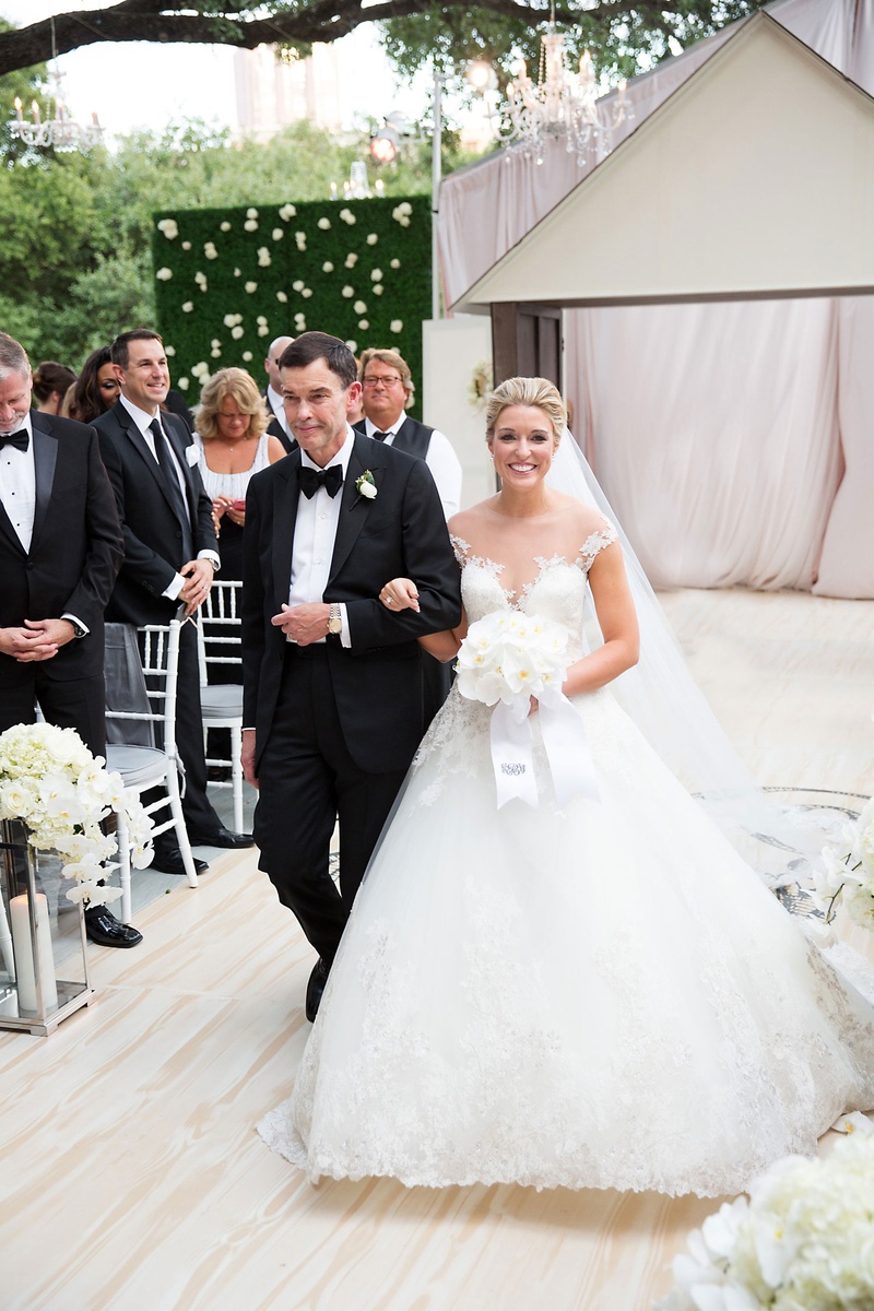 Bride Descending Aisle with Father of Bride
Photography: Sarah Kate, Photographer
Read More:
http://www.insideweddings.com/weddings/outdoor-fall-ceremony-opulent-tented-reception-in-dallas-texas/1022/ Wedding outdoor hedge wall pink drapery wood aisle bride in romona keveza ball gown dad in tuxedo