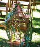 Copper Lantern with Foliage and Blush Flowers
Photography: Callaway Gable
Read More:
http://www.insideweddings.com/weddings/alfresco-summer-wedding-with-lush-foliage-accents-in-california/805/ a large copper lantern lining the aisle featuring winding green foliage and blush flowers