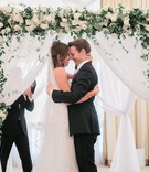 Newlyweds Embrace at Altar
Photography: Jillian Rose Photography
Read More:
http://www.insideweddings.com/weddings/indoor-wedding-with-beach-inspired-color-palette-in-santa-monica/1052/ bride in j. mendel wedding dress, groom in suitsupply suit, couple hugging in front of arch