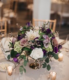 Centerpiece with Pops of Purple
Photography: Justin Johnson Photography
Read More:
http://www.insideweddings.com/weddings/metallic-dusty-purple-color-palette-at-venue-with-stunning-views/1305/ centerpiece with wildflowers, ivory dahlias, amnesia roses, succulents, eucalyptus, & purple blooms
