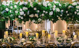 Tall Centerpiece with Hydrangeas %26 Roses
Photography: K. Thompson Photography
Read More:
http://www.insideweddings.com/weddings/traditional-ceremony-ballroom-reception-with-blue-gold-decor/1201/ wedding reception long table gold chairs candles tall centerpiece white rose hydrangea blue flowers